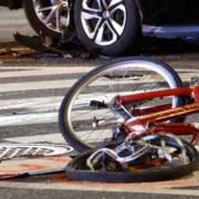 A bicycle lies crumpled in the street after being hit by a car in a bicycle accident