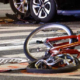 A bicycle lies crumpled in the street after being hit by a car in a bicycle accident