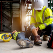 A construction worker helps his injured coworker following a workplace accident